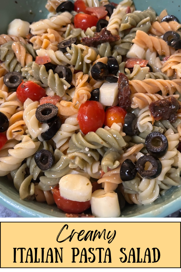 colorful pasta salad with rotini pasta and veggies, tossed in a bowl with dressing. Texas: Creamy Italian Pasta Salad (pin for pinterest)