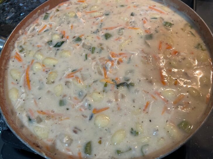 chicken and gnocchi soup simmering on stove