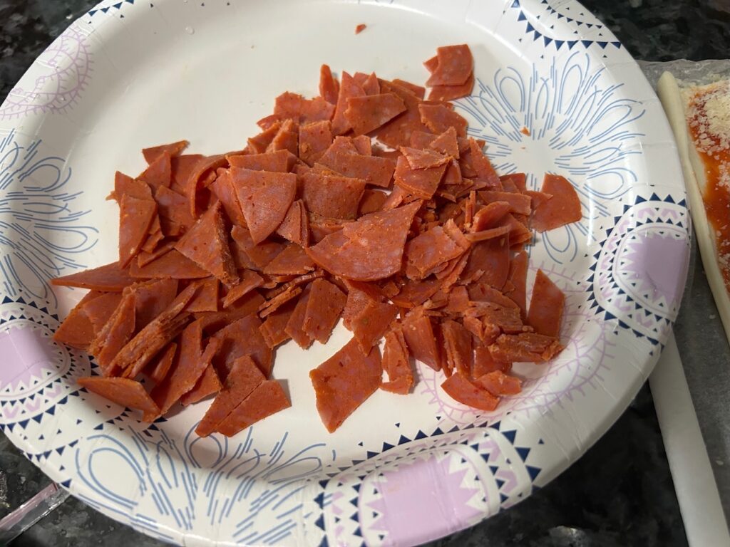 diced pepperoni on paper plate