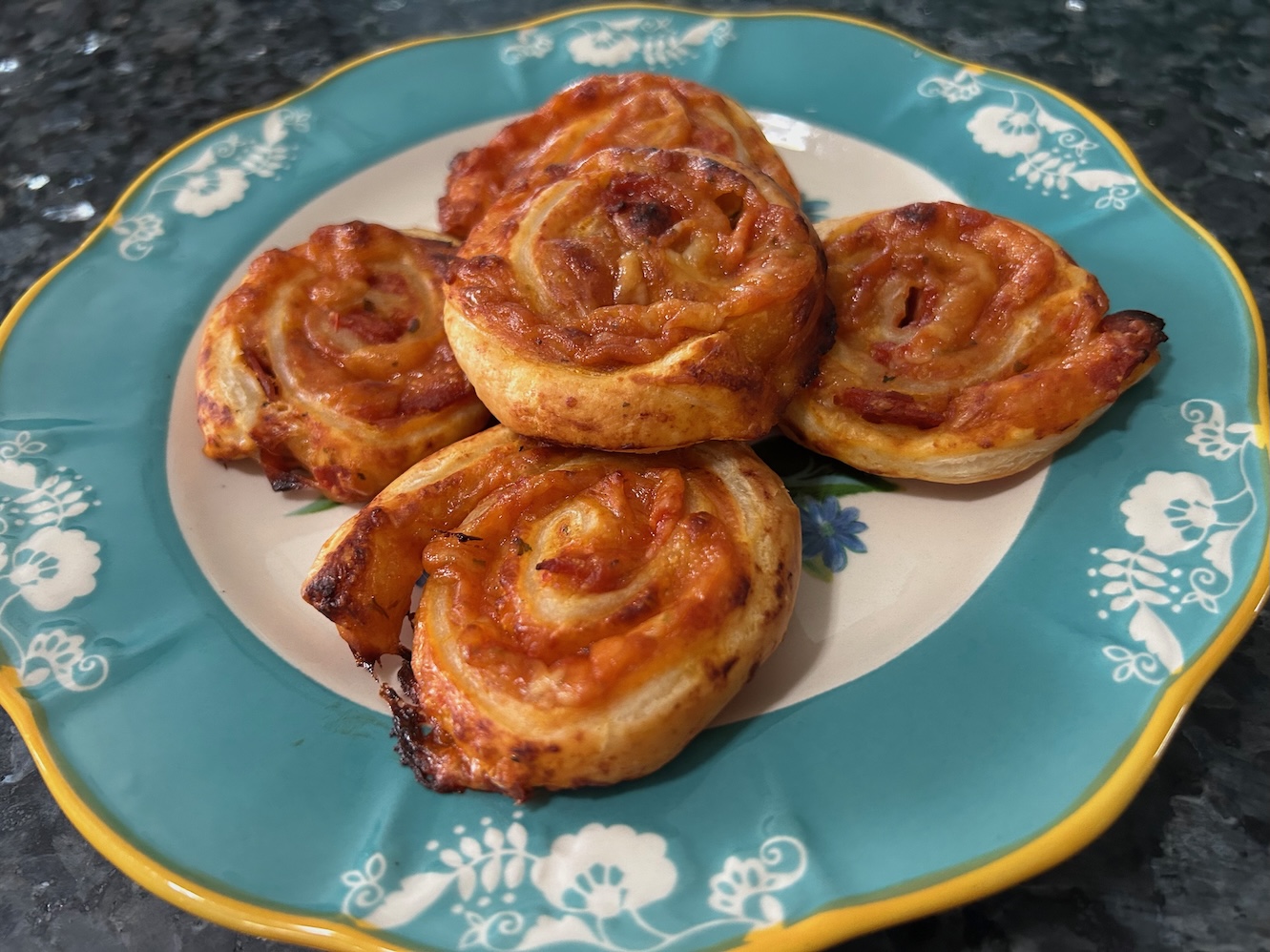pizza pinwheels stacked on plate