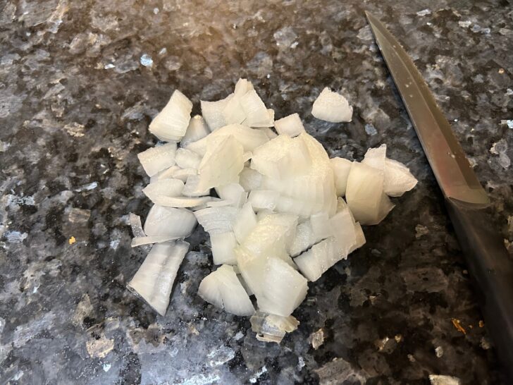 chopped onions with knife nearby