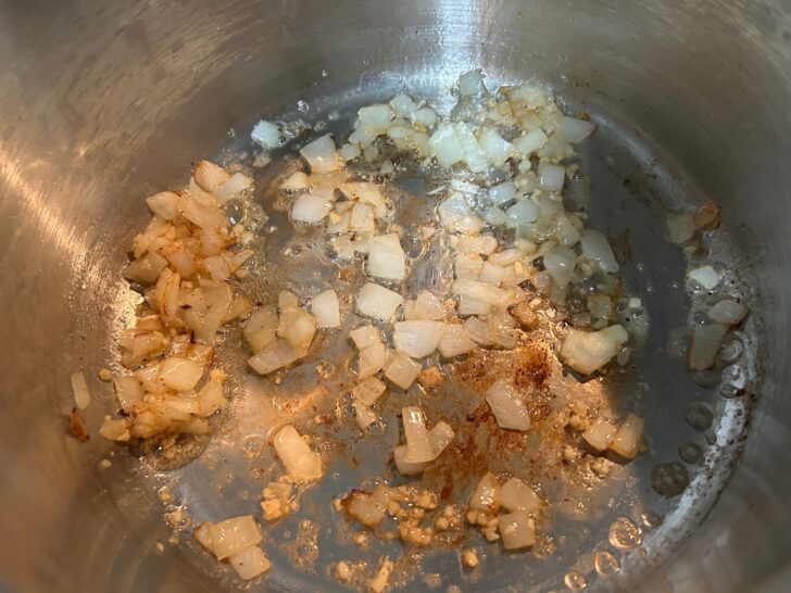 onions, garlic, and butter sautéing in pan