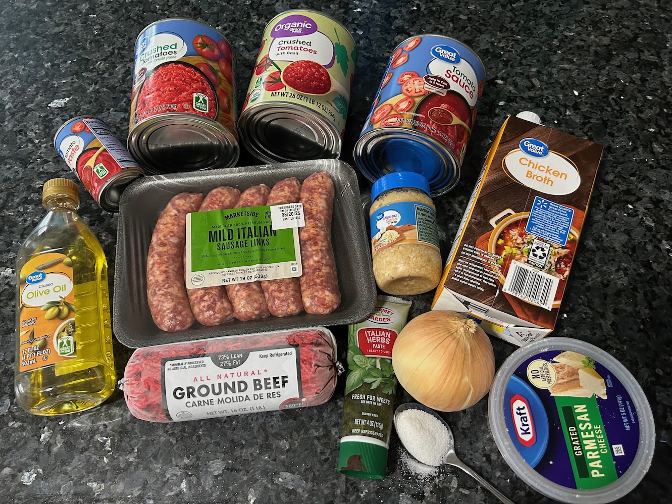 Sunday gravy ingredients: sauces, meats, broth, olive oil, spices, veggies