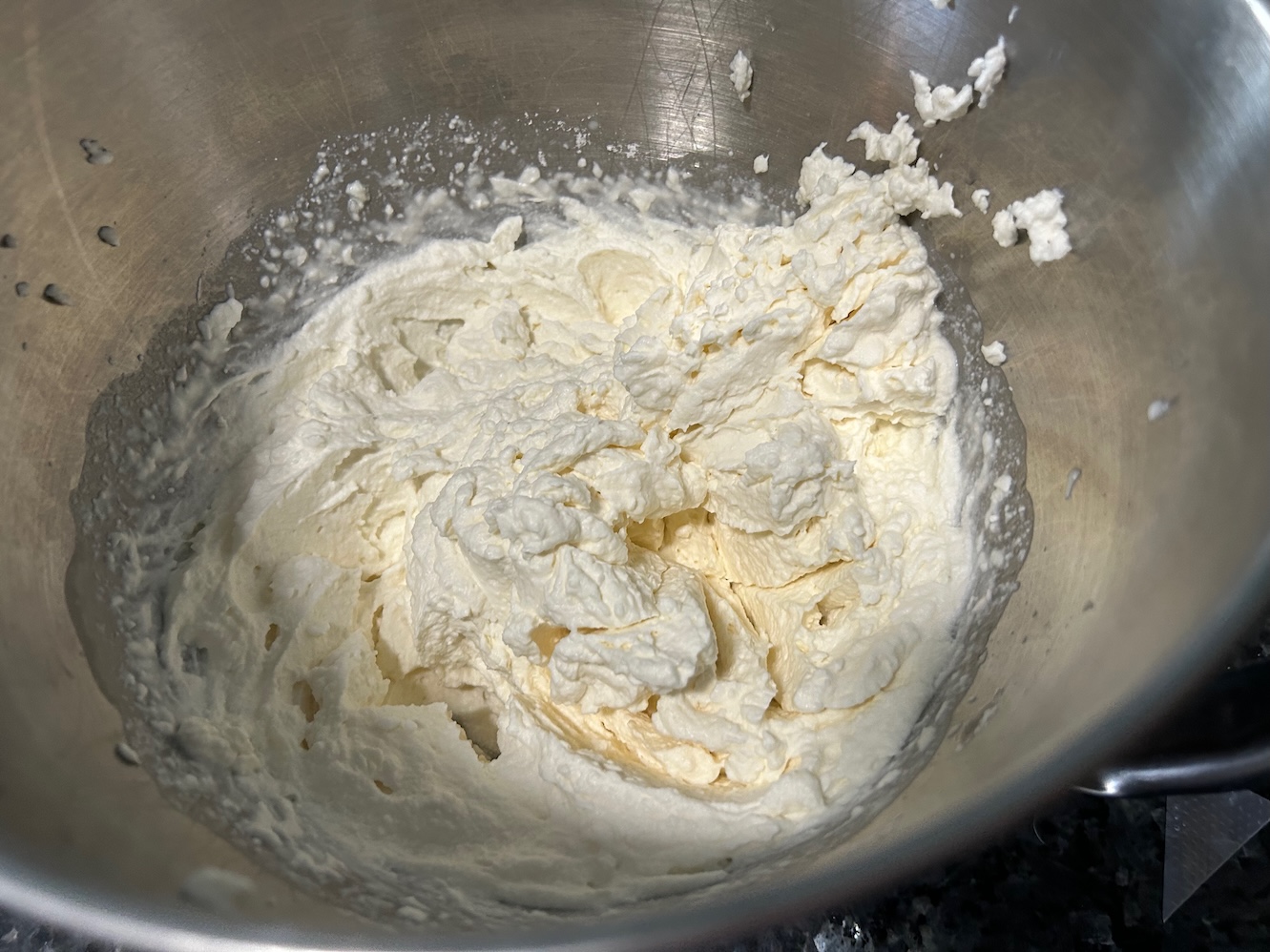 whipped cream frosting in mixing bowl