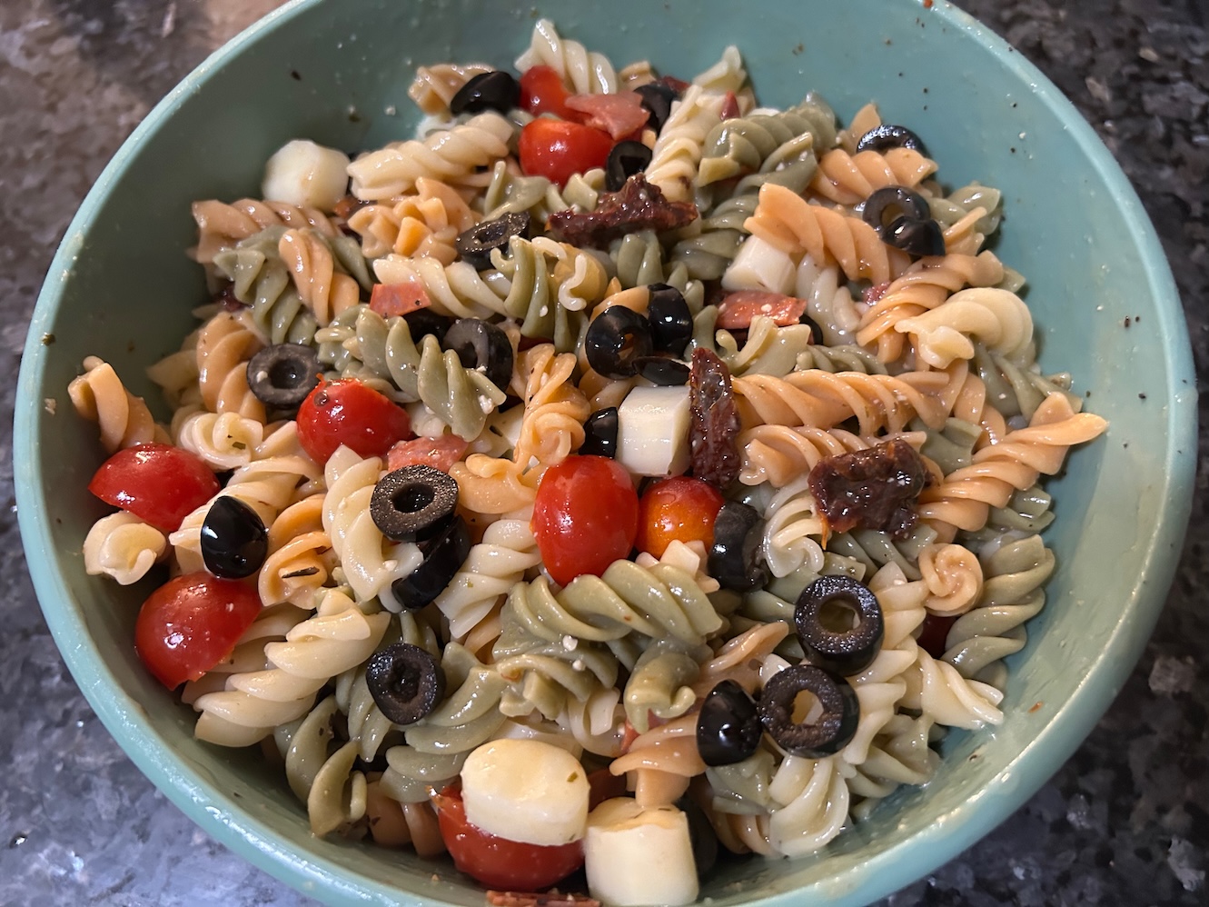 colorful pasta salad with rotini pasta and veggies, tossed in a bowl with dressing. Texas: Creamy Italian Pasta Salad 