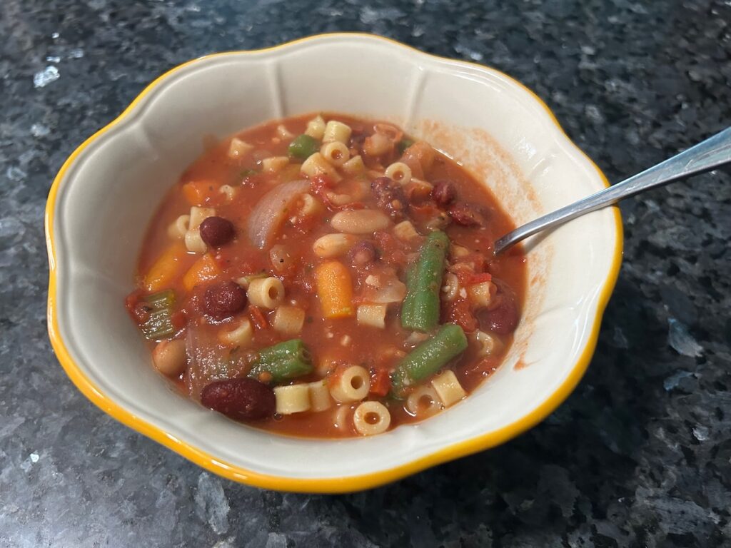 minestrone soup in bowl with spoon