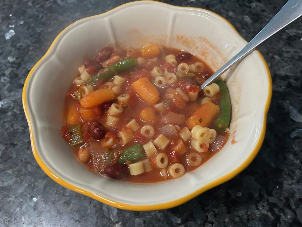 minestrone soup in bowl with spoon