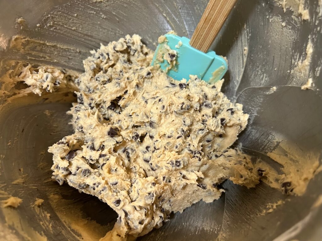 Rolls Royce cookies batter in bowl with chocolate chips added