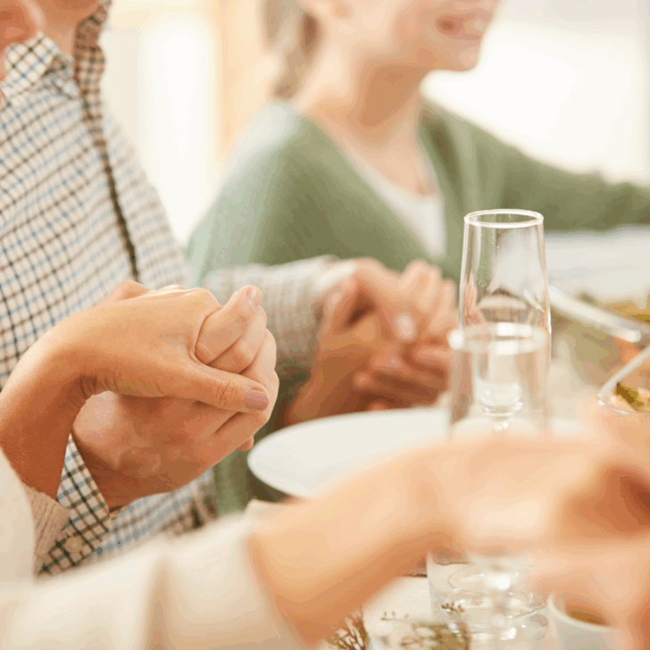 family praying at table