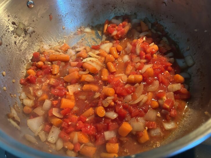 veggies in pot with tomatoes simmering