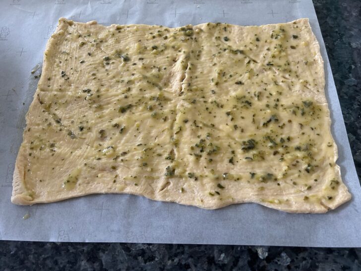 crescent rolls, opened up and spread with herbs and butter
