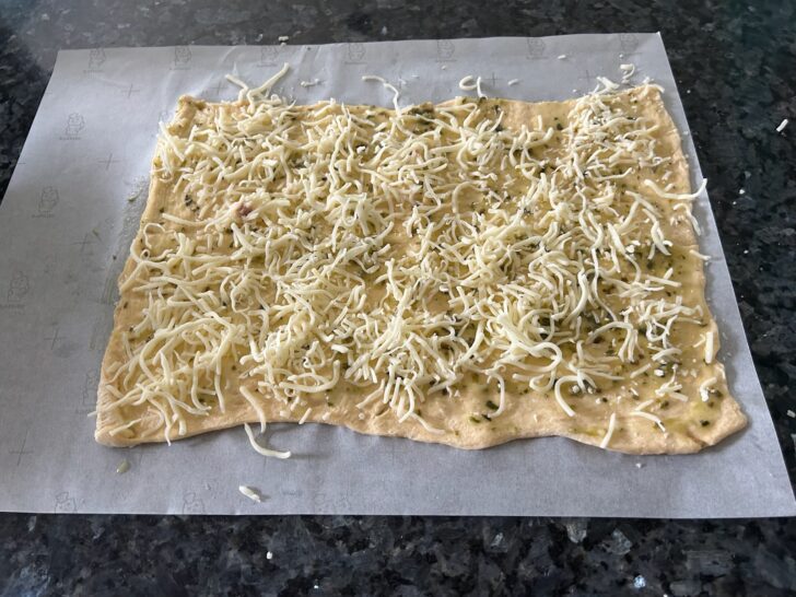cheese added to herbed crescent roll dough