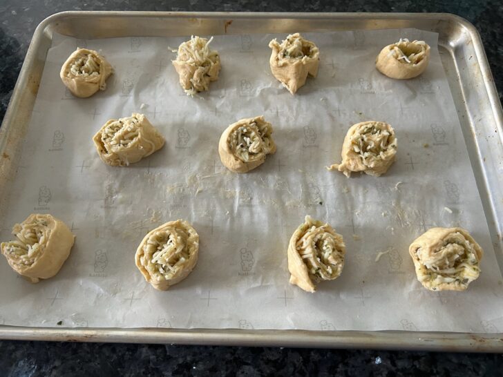 unbaked crescent roll pinwheels, cut and on cookie sheet